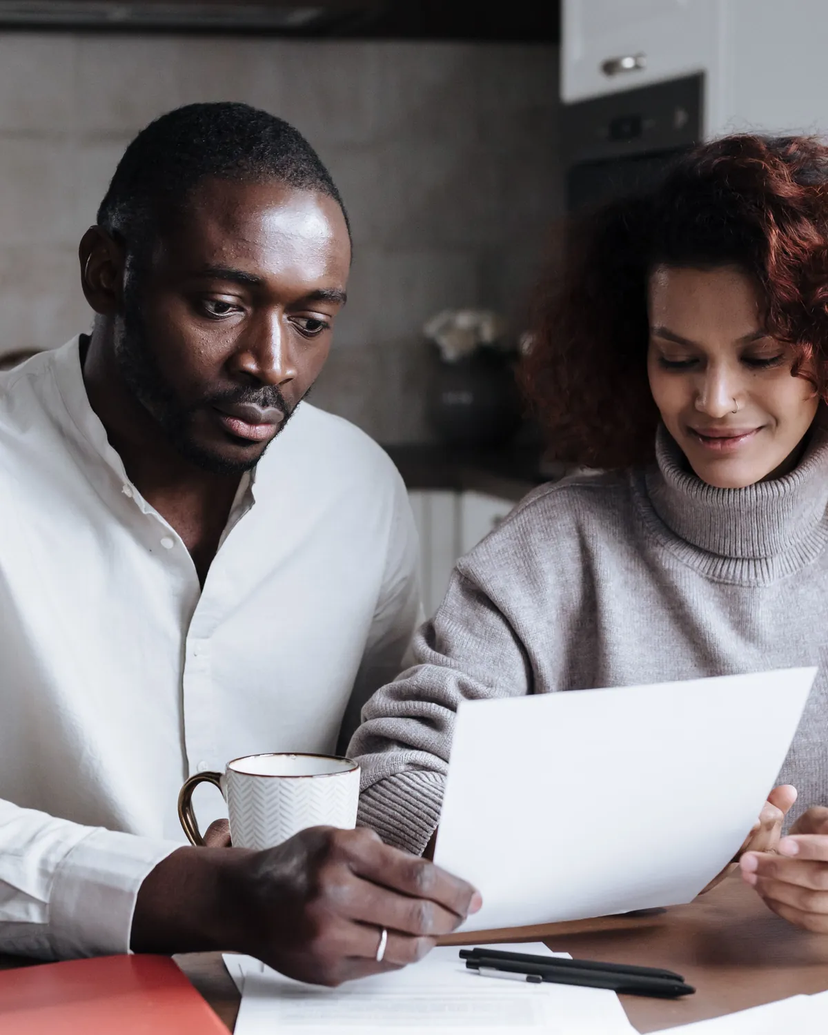 A couple reviewing paperwork together at home